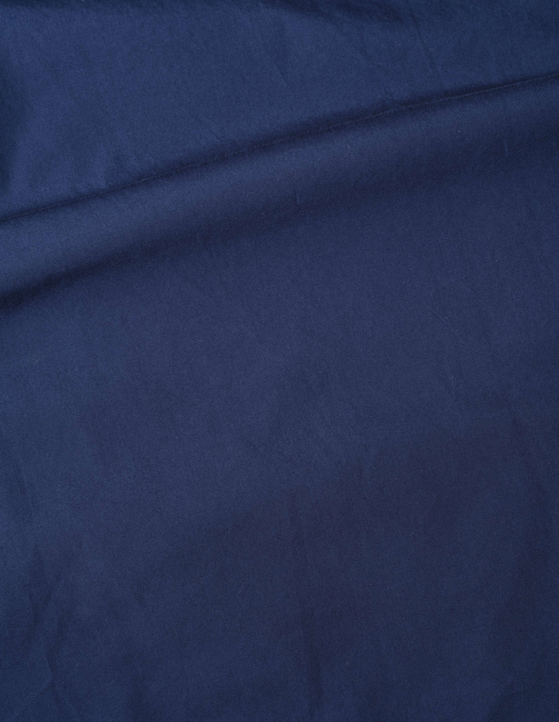 Blue washed cotton poplin asymmetric round collar shirt, fabric swatch.