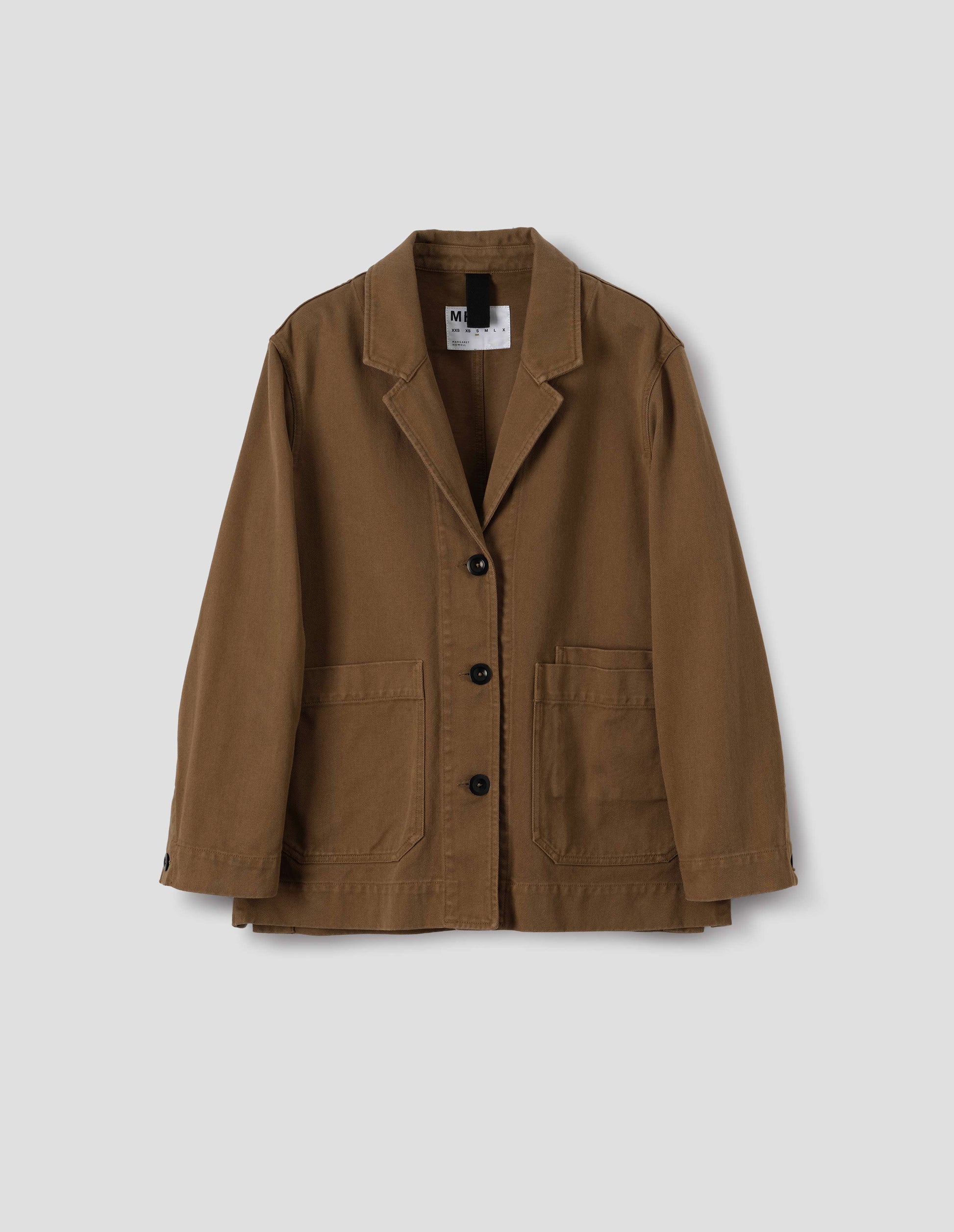 Brown cotton blazer, with large front pockets and three dark brown buttons, front flat lay view.