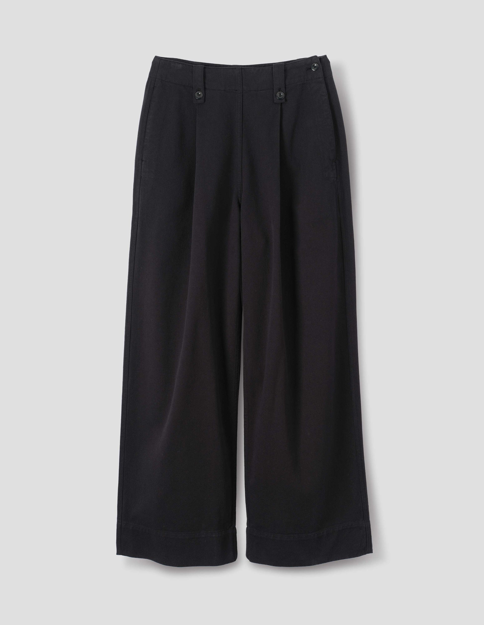 Black cotton tencel wide leg trousers with a button-fastening belt loops and two front pleats, front flat lay view.