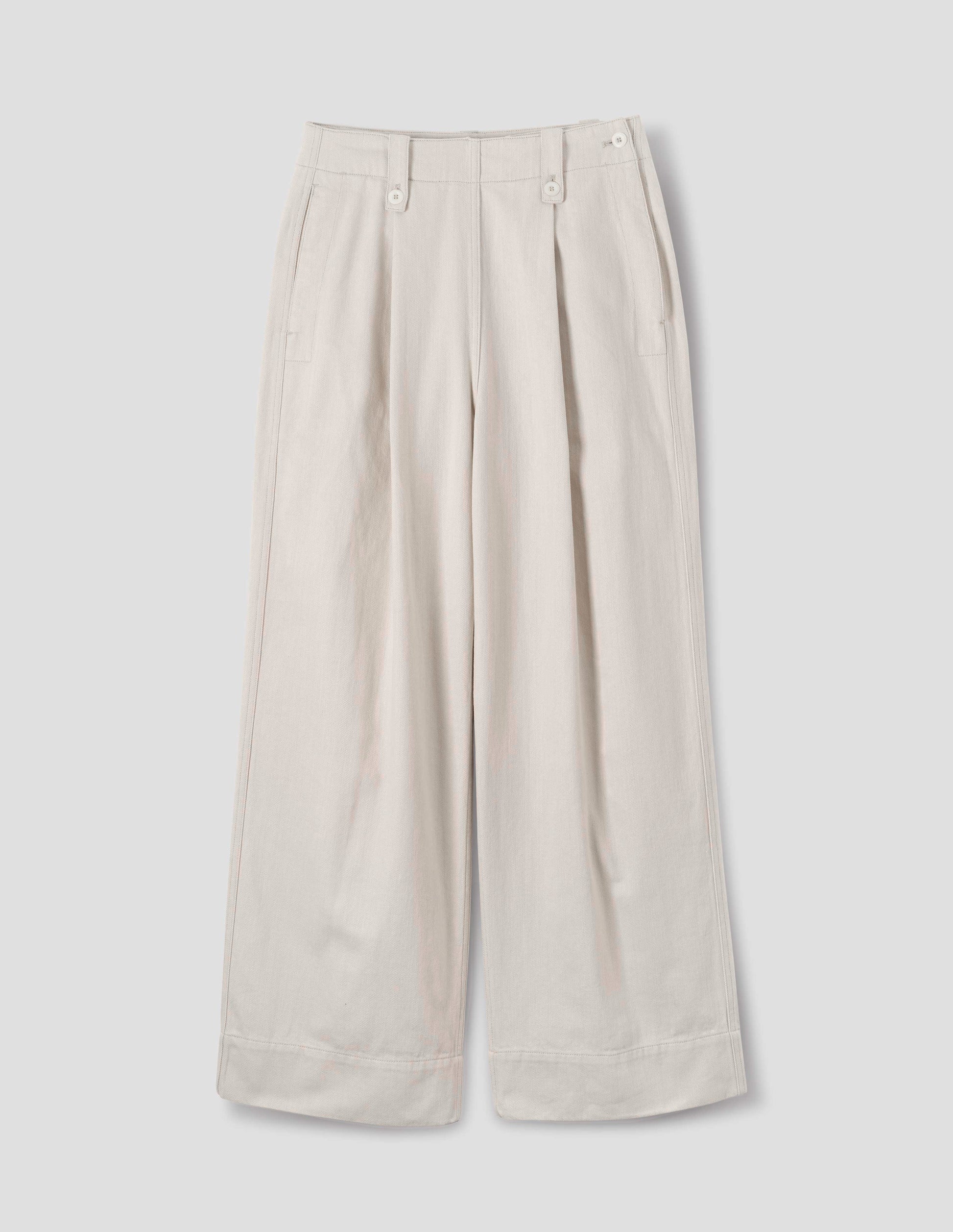 Off white trousers with with grown-on waistband, button-fastening belt loops, a side opening with integrated side seam pockets, and two front pleats. Front flat lay view.