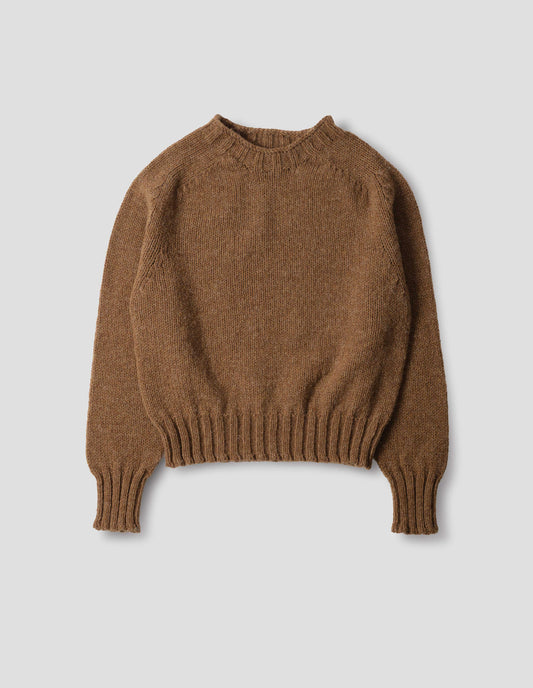Orangey brown wool crew neck jumper with saddle sleeves and contrasting rib on the neck, cuffs and hem. Front flat lay view.
