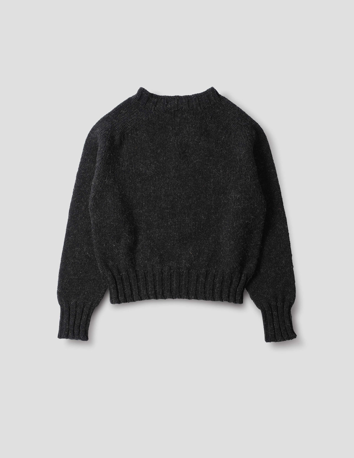 Dark grey wool jumper with saddle sleeve and contrast rib on neckline, cuffs and hem. Back flat lay view.