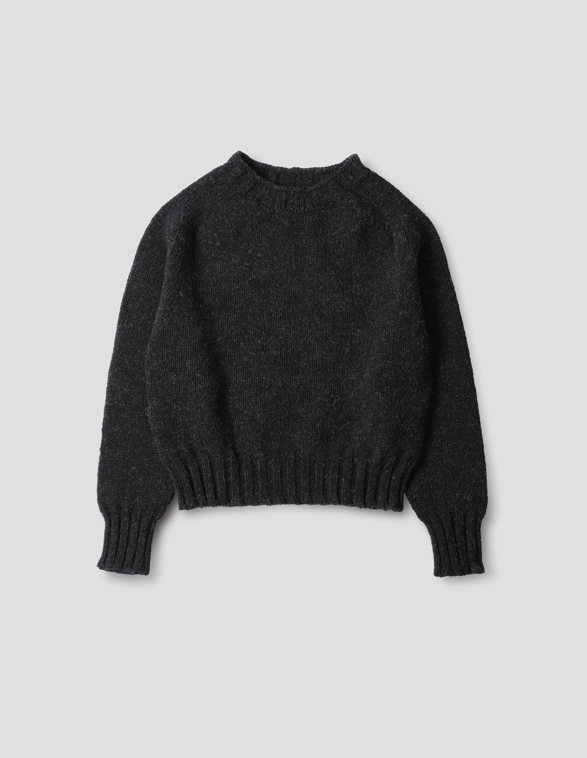 Dark grey wool jumper with saddle sleeve and contrast rib on neckline, cuffs and hem. Front flat lay view.