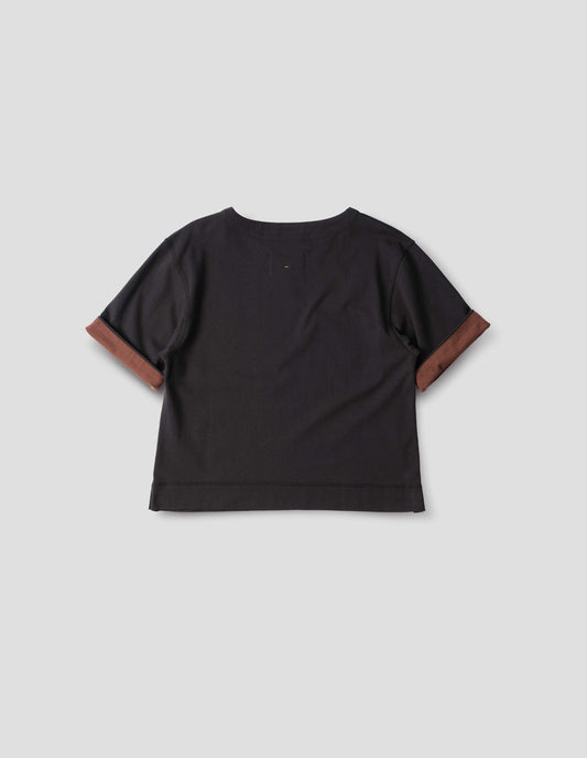 Black short sleeve T shirt with a wide neck, deep faced cuffs in with a contrast brown colour on the reverse, and flatlock stitching on the hem and armholes, back flat lay view.