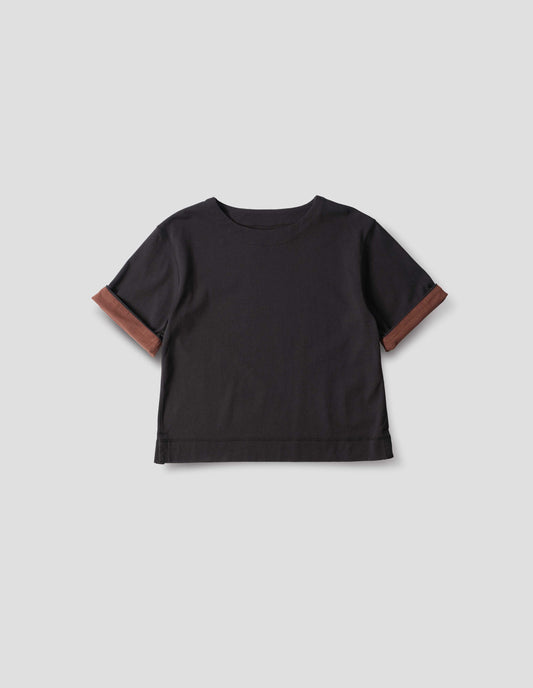 Black short sleeve T shirt with a wide neck, deep faced cuffs in with a contrast brown colour on the reverse, and flatlock stitching on the hem and armholes, front flat lay view.