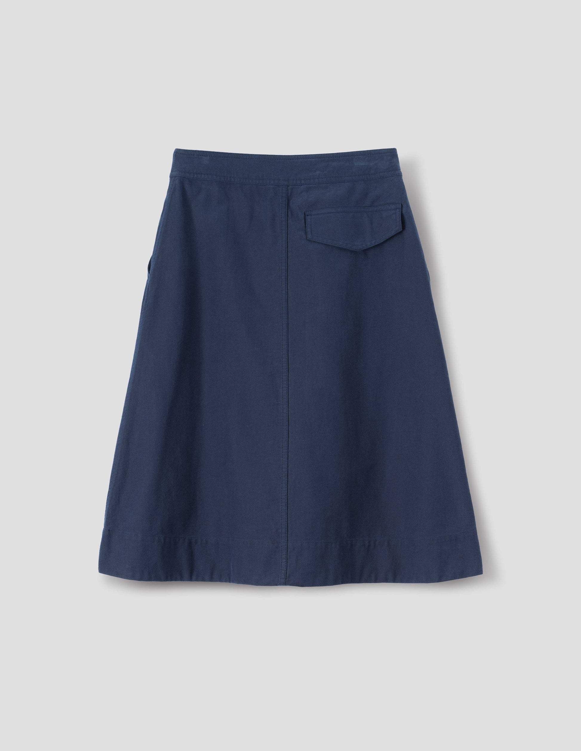 Dark blue cotton skirt, with back flap pocket, back flat lay view.