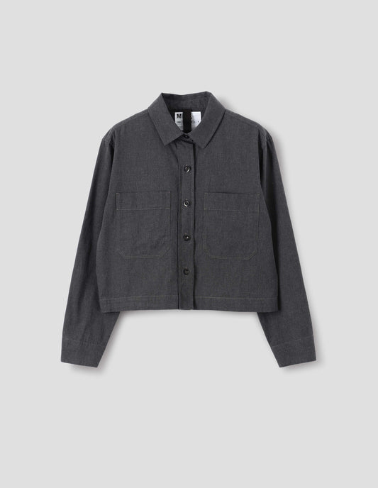 Dark grey cotton chambray shirt with patch chest pockets, dark buttons and with a forward shoulder seam, front flat lay view.