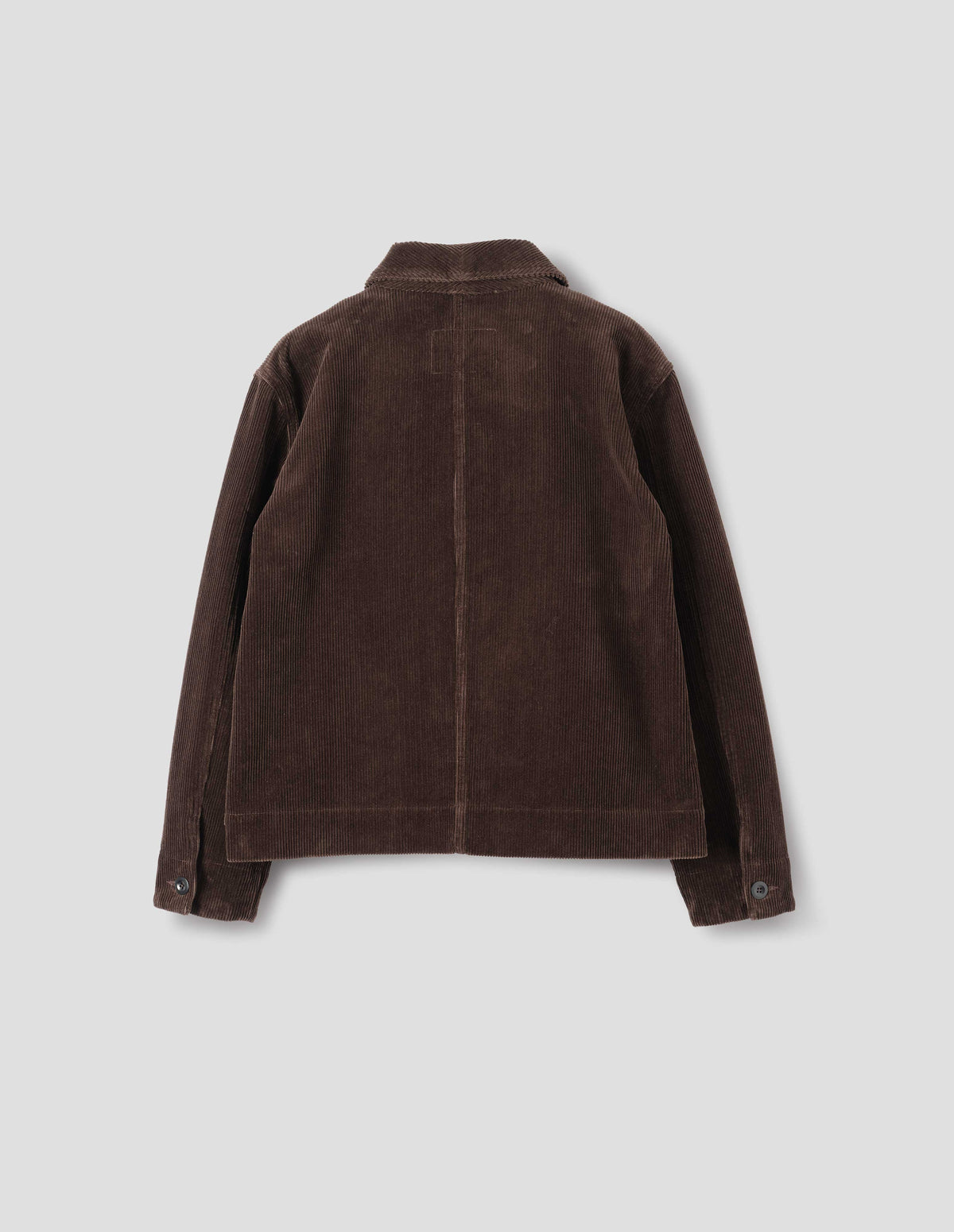 Brown corduroy jacket with a one piece collar, a dropped shoulder and shirt cuffs, back flat lay view.