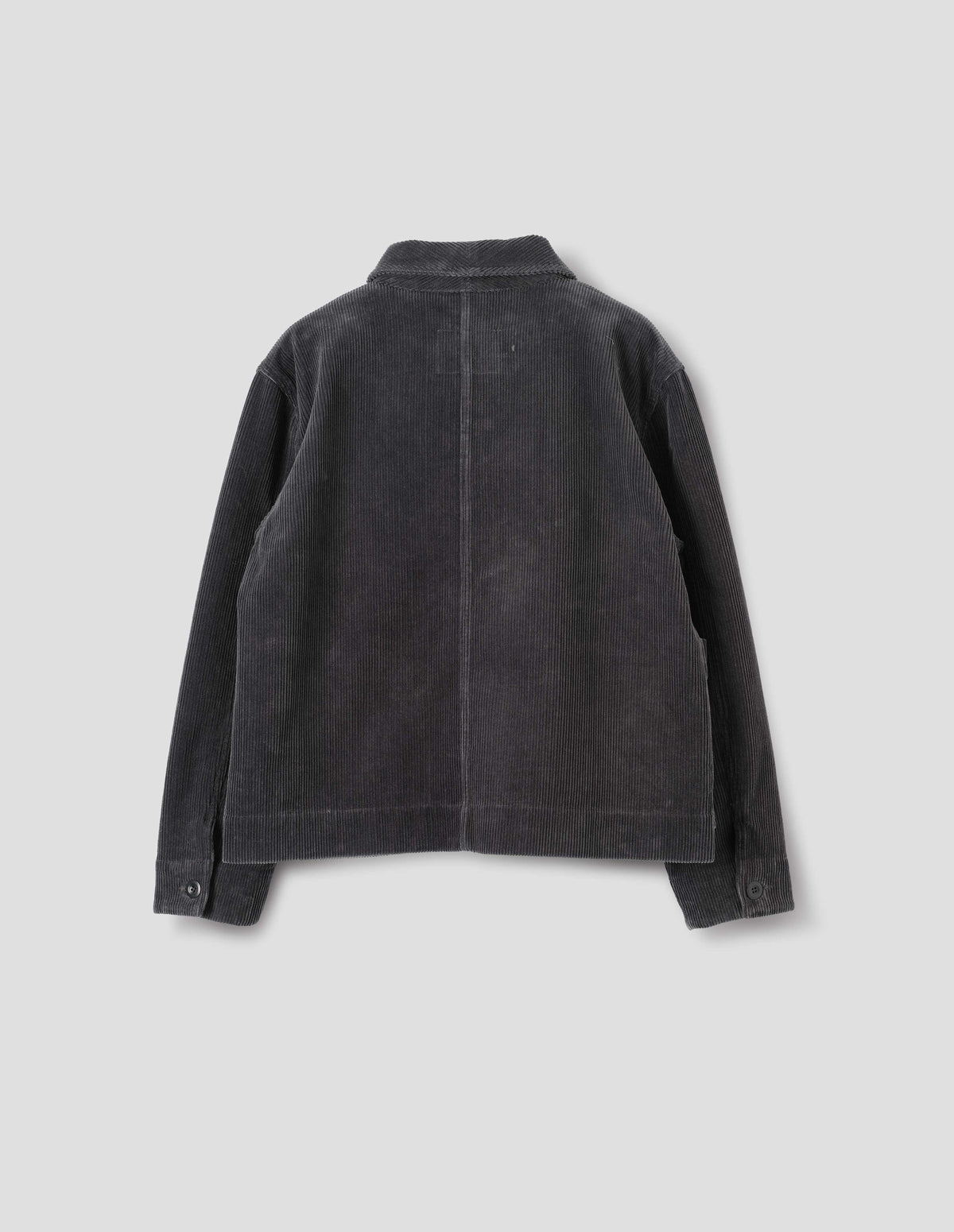 Dark grey cotton corduroy jacket, with one piece collar, dropped shoulder and corozo button closure shirt cuffs. Back flat lay view. 