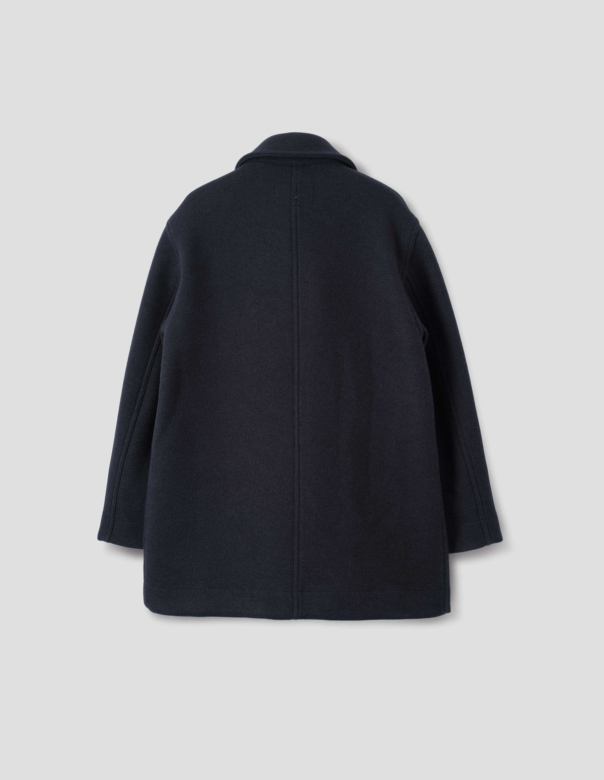 Dark blue coat with a dropped shoulder, centre back seam, back flat lay view.