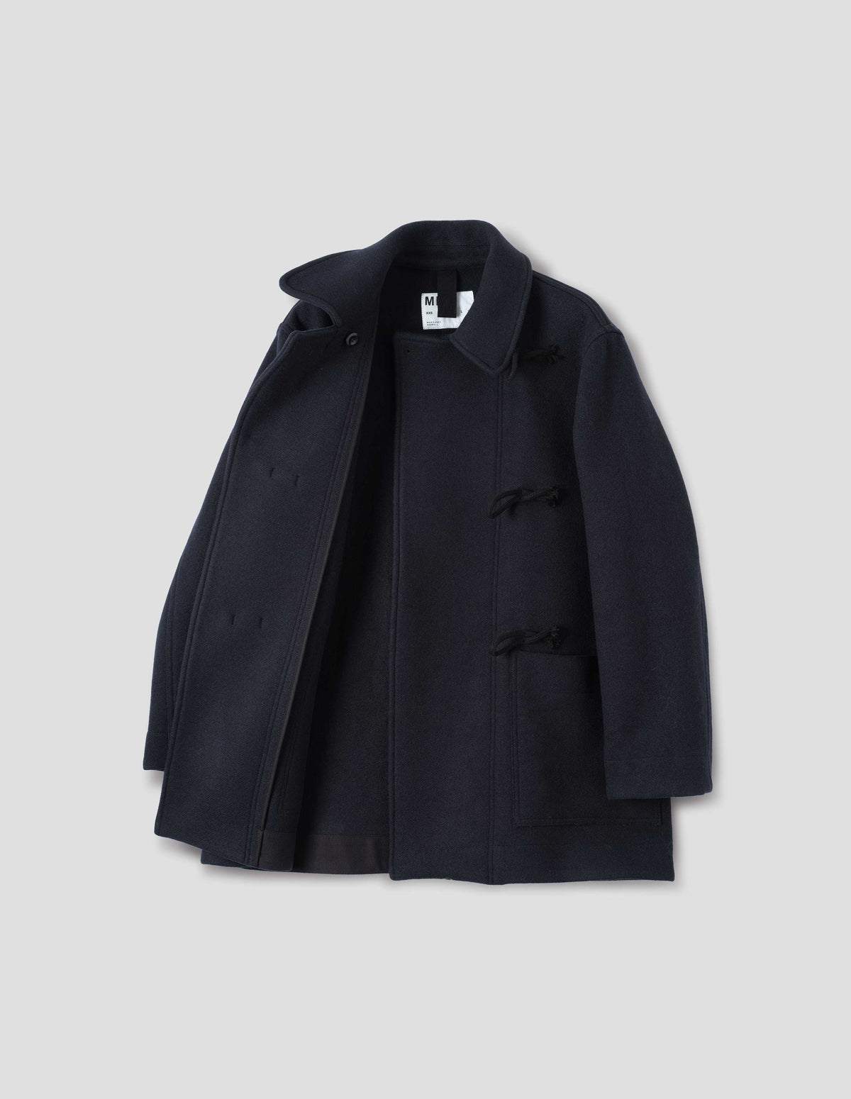 Dark blue coat with wide front wrap fastening with wooden toggles, patch pockets, unlined, open flat lay view.