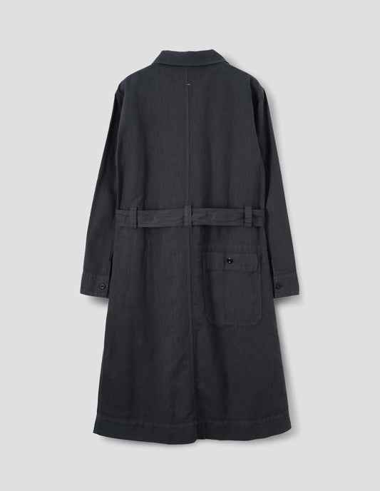 Dark navy overall dress with button-fastening split cuffs and button-through patch pocket at the back, finished with a removable belt. Back flat lay view.