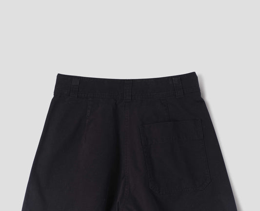 Black cotton trousers with a back patch pocket and shaping darts, back flat lay view.