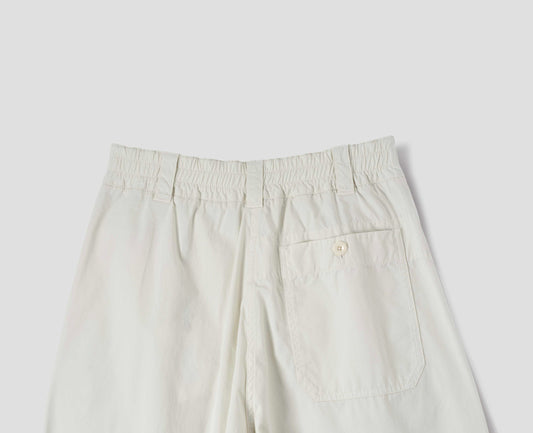 Off white cotton culottes, with elasticated waist and belt loops, a patch pocket with button, back flat lay view