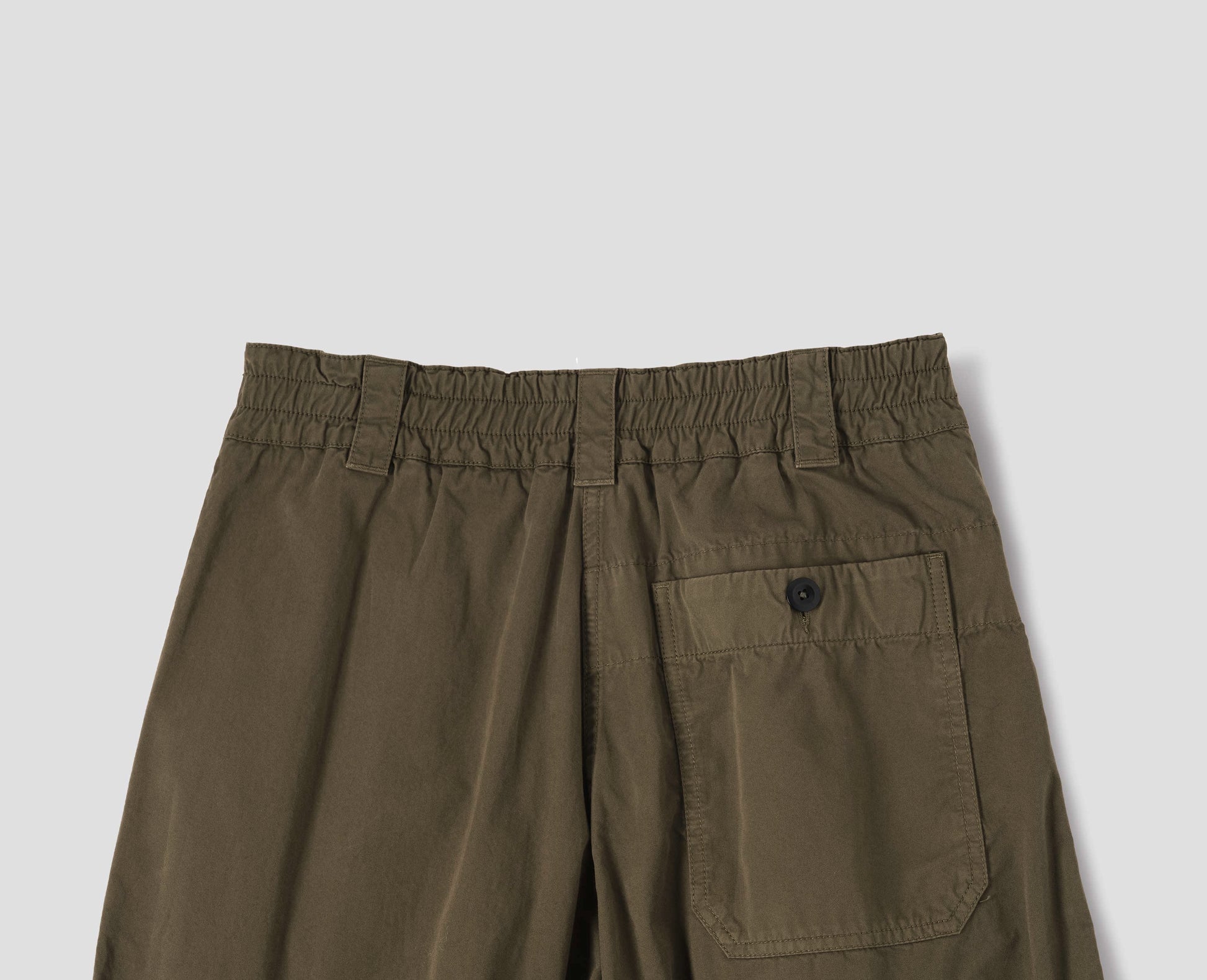 Green brown cotton culottes, with elasticated waist and belt loops, a patch pocket with button, back flat lay view.