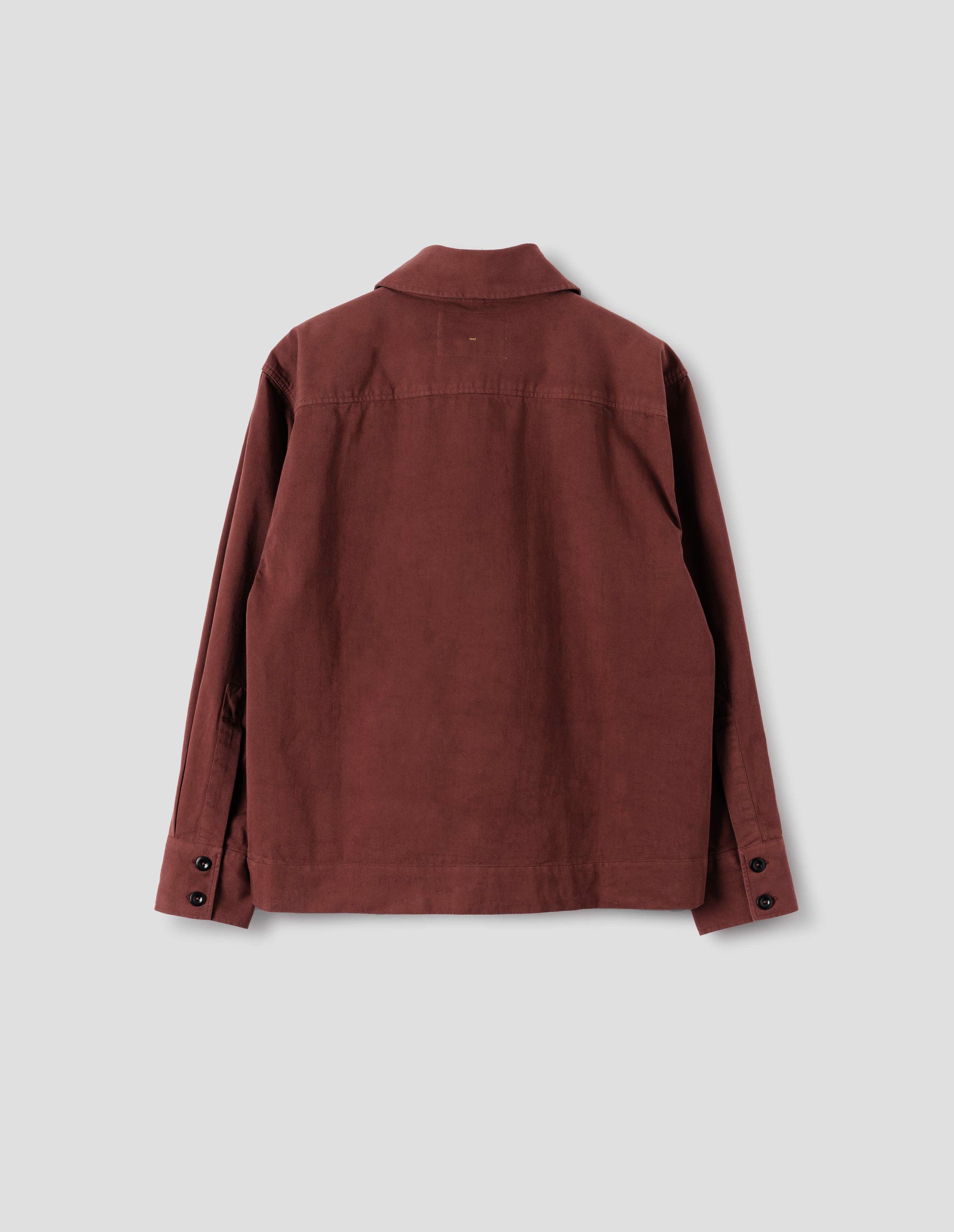 Reddish cotton shawl collar overshirt with a forward-positioned shoulder seam, back yoke detailing and two dark button fastening on cuffs, back flat lay view.