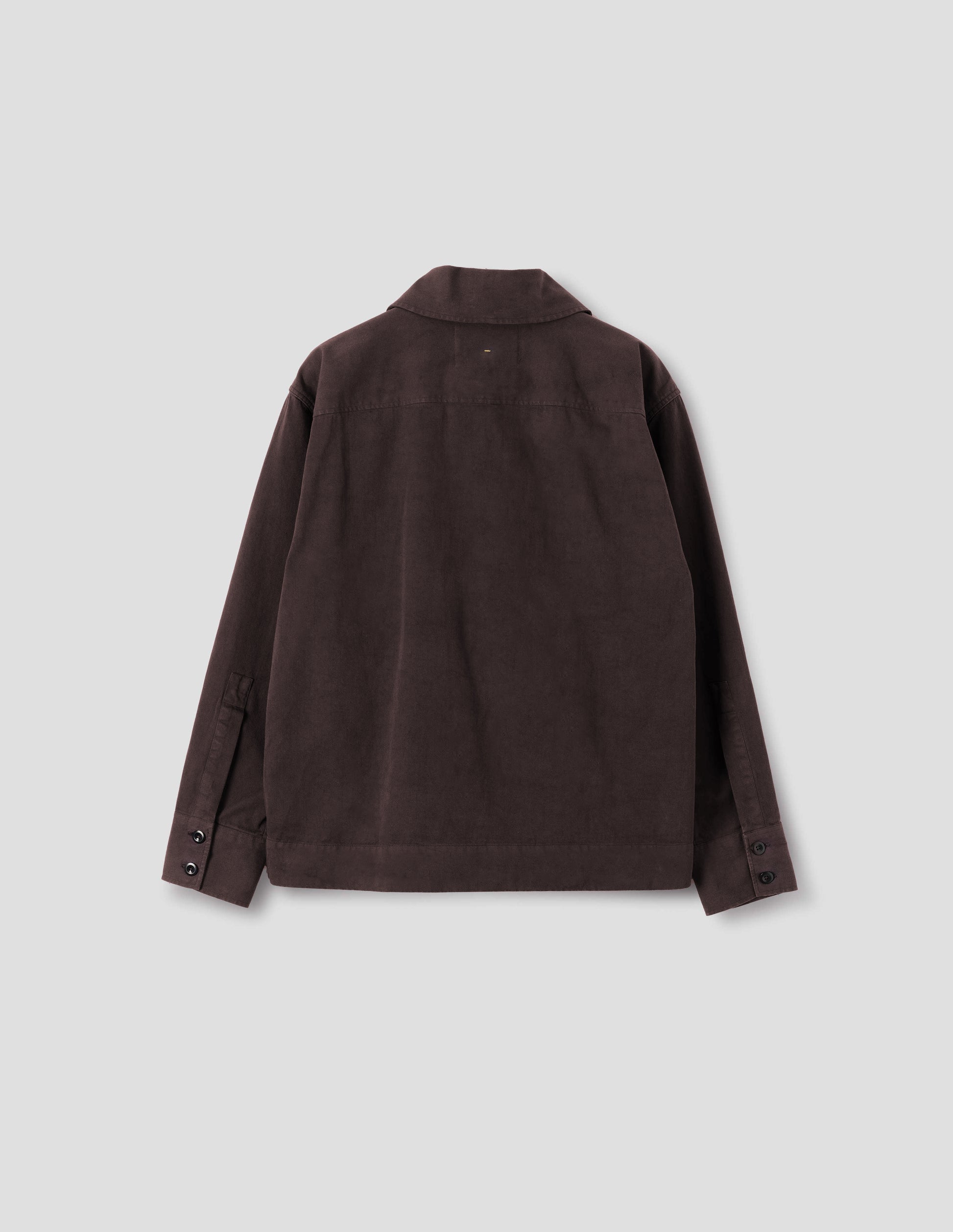 Dark brown cotton shawl collar overshirt with a forward-positioned shoulder seam, back yoke detailing and two dark button fastening on cuffs, back flat lay view.