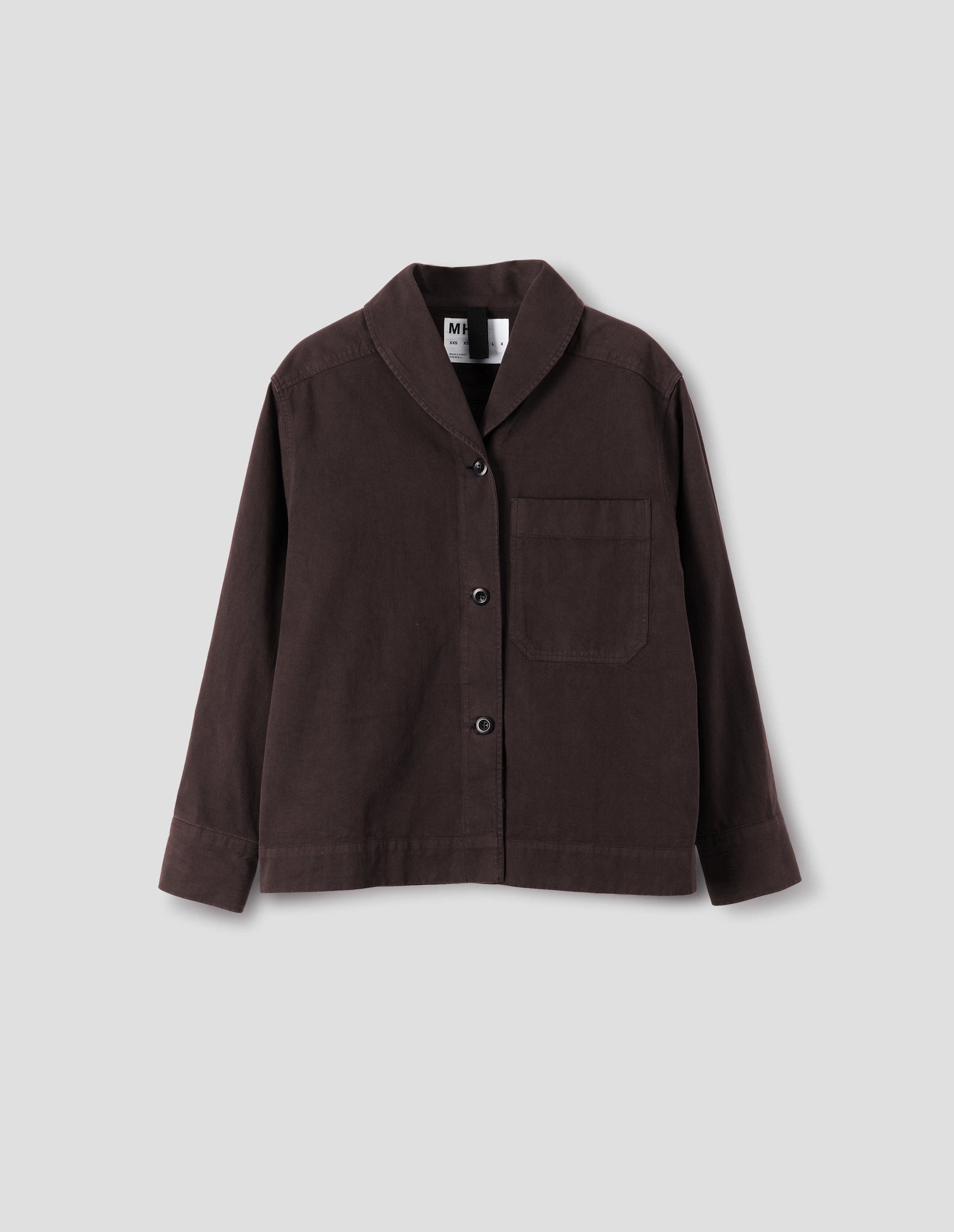 Dark brown cotton shawl collar overshirt with dark buttons, a forward-positioned shoulder seam and a front patch pocket, front flat lay view.