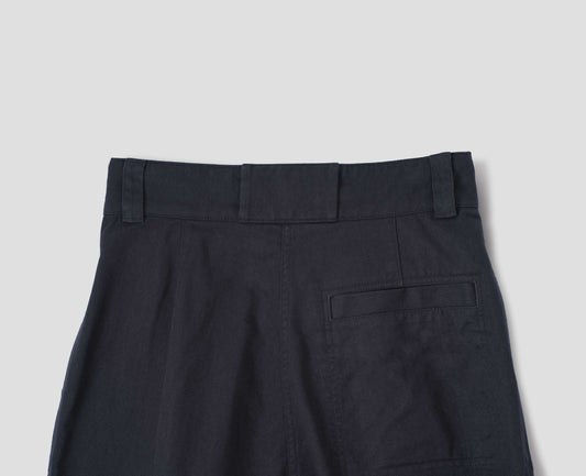 Dark blue cotton trousers, with belt loops a single welt pocket, back flat lay view.