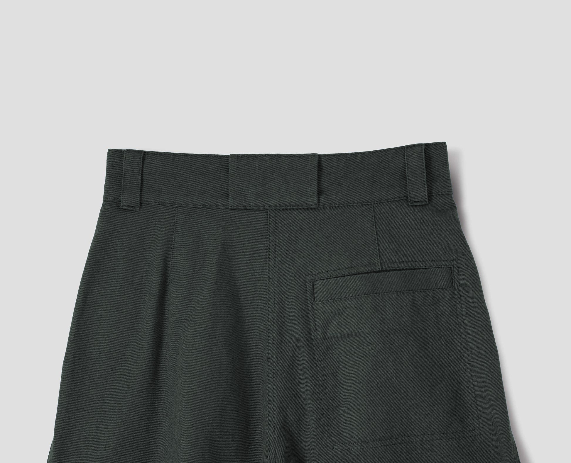 Greyish green cotton high waisted trousers with a stitch-through back welt pocket, back flat lay view.