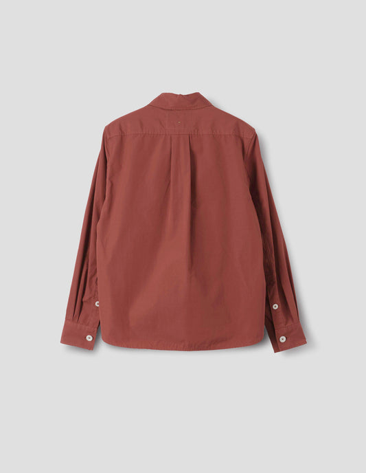 Red cotton poplin shirt with a box pleat on the back yoke, long sleeves with a button-through cuffs and a curved hem. Back flat lay view.