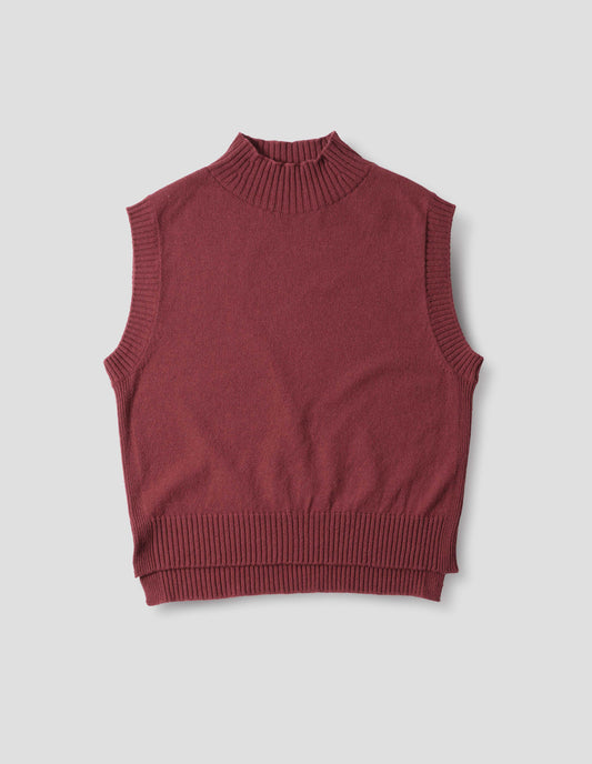 Reddish wool cotton slipover with a high rib neck, rib armholes and hem and split stepped hem, front flat lay view.