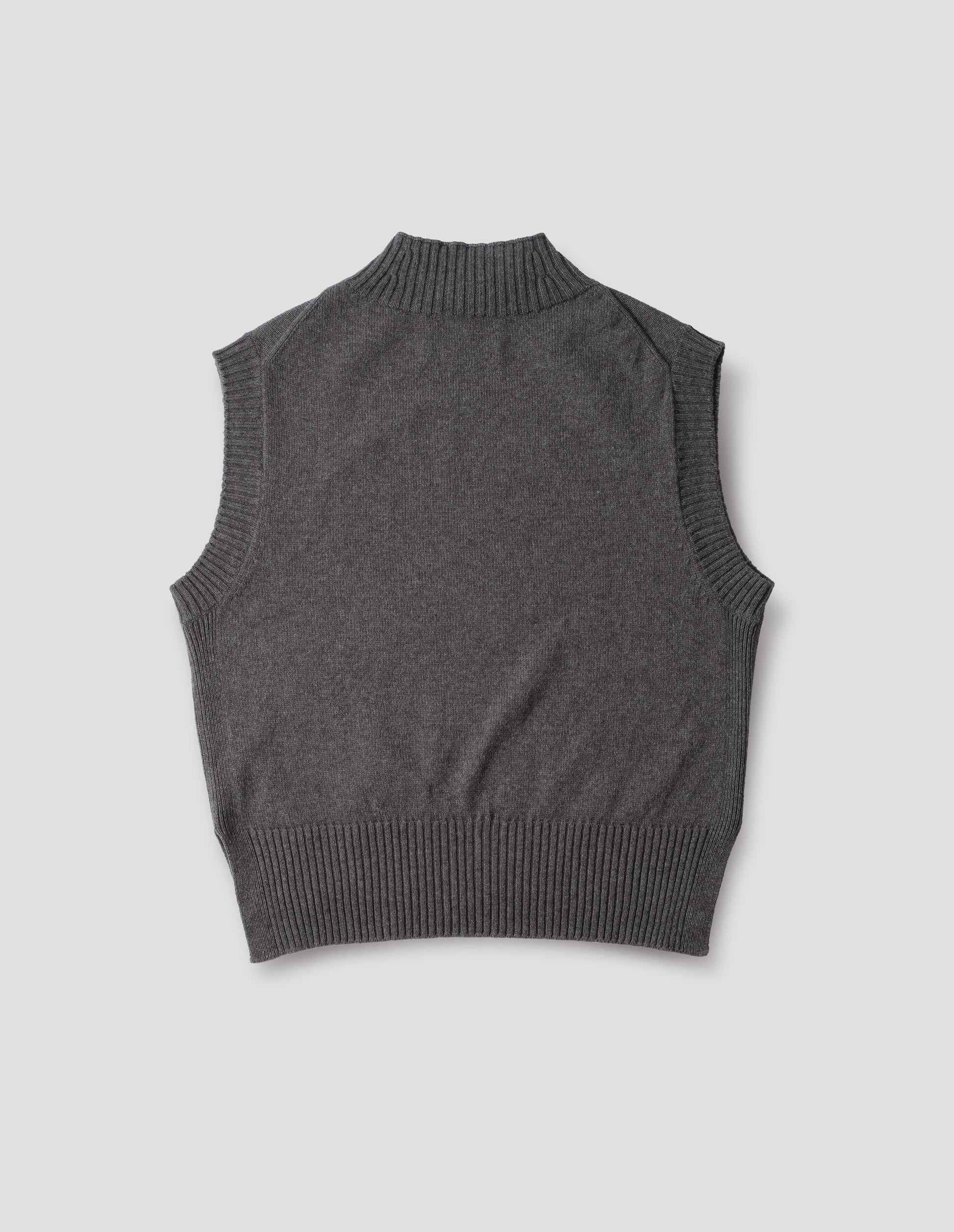 Grey wool cotton slipover with a high rib neck, rib armholes and hem, back flat lay view.
