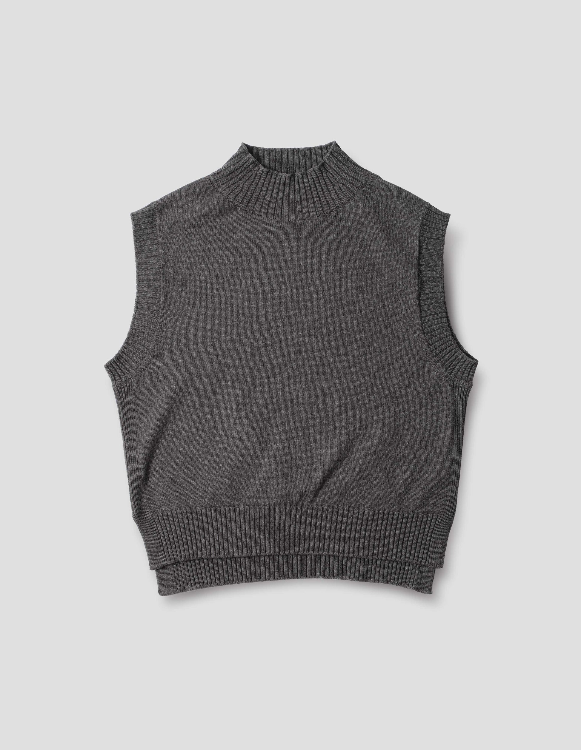 Grey wool cotton slipover with a high rib neck, rib armholes and hem and split stepped hem, front flat lay view.