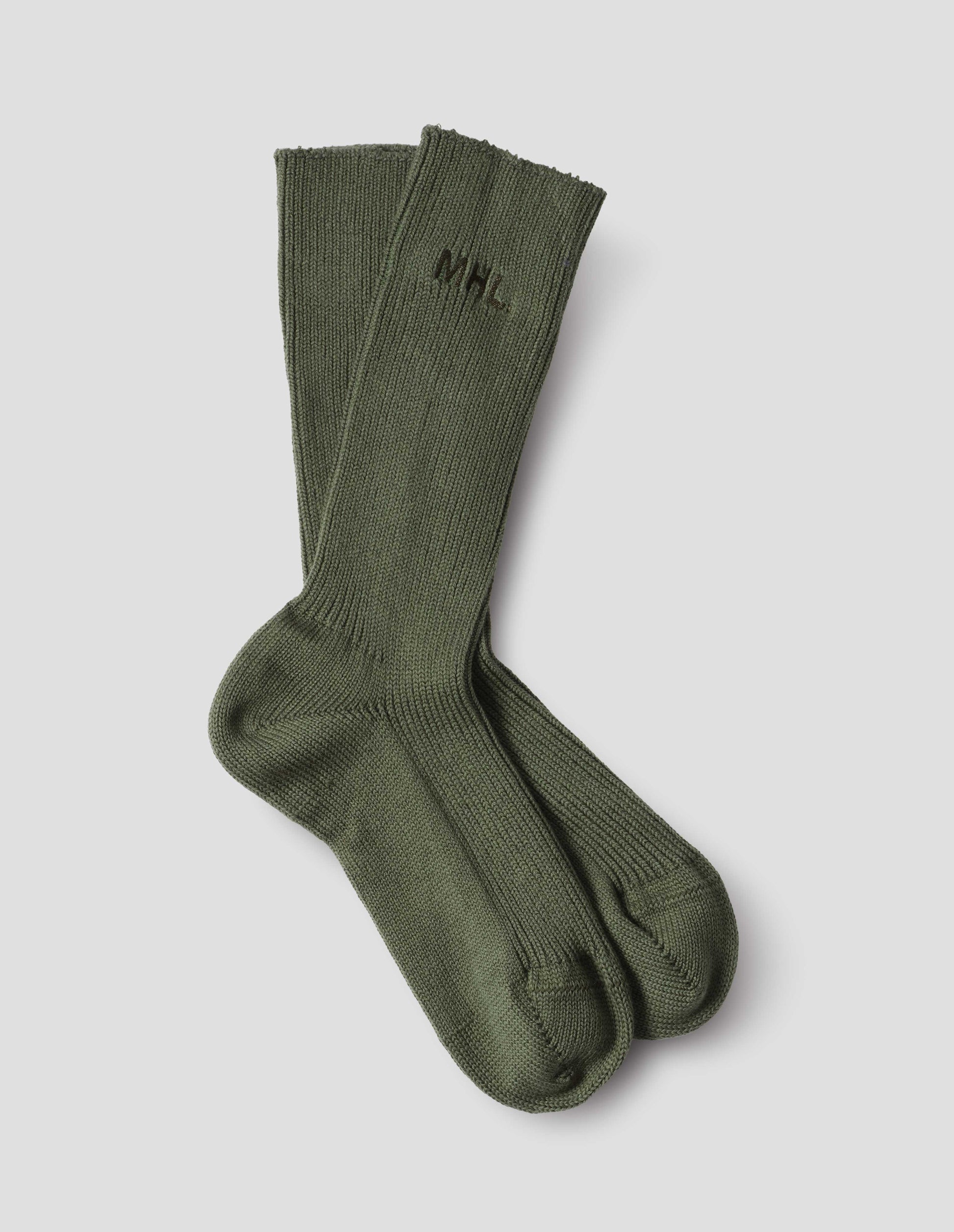 Dark green cotton socks, with embroidered MHL logo, front flat lay view.