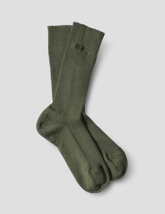 Dark green cotton socks, with embroidered MHL logo, front flat lay view.