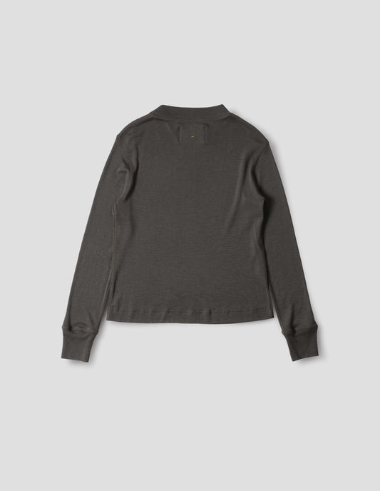 Dark grey long sleeve t shirt with set-in sleeves, a rib neck and cuffs with flatlock stitching. Back flat lay view.