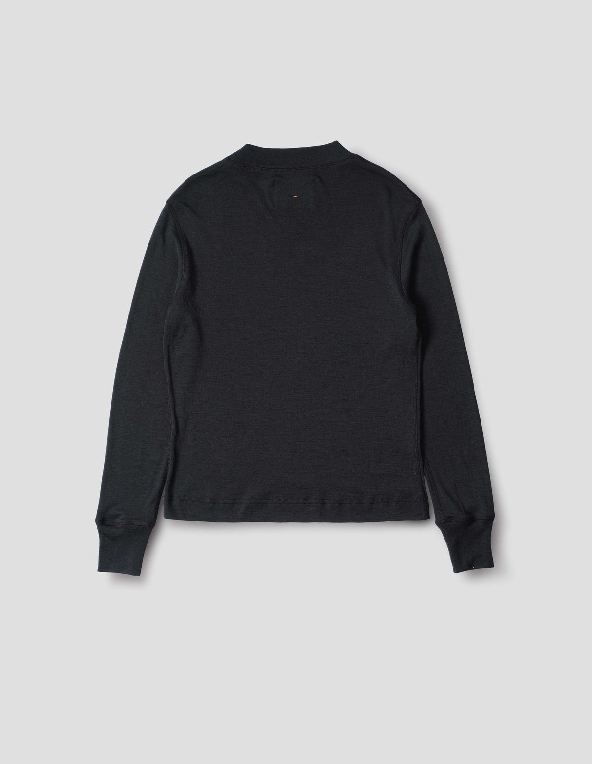 Black long sleeve t shirt with set-in sleeves, a rib neck and cuffs with flatlock stitching. Back flat lay view.