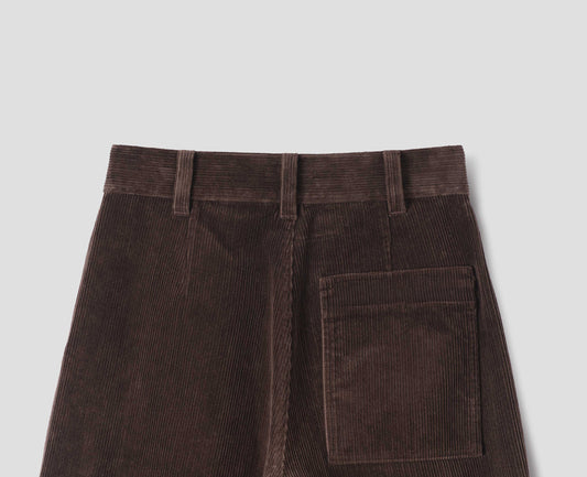 Brown corduroy trousers with a back patch pocket and shaping darts, back flat lay view.