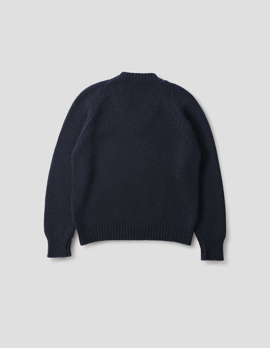Dark blue cashmere wool jumper with raglan sleeve and fully fashioned arm hole, ribbed neck, cuffs and hem. Back flat lay view.