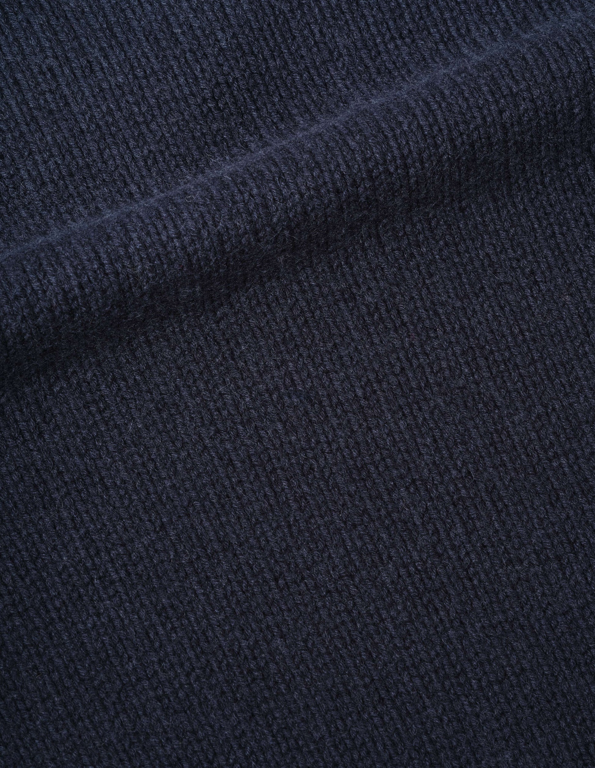 Dark blue soft cashmere wool jumper fabric swatch.
