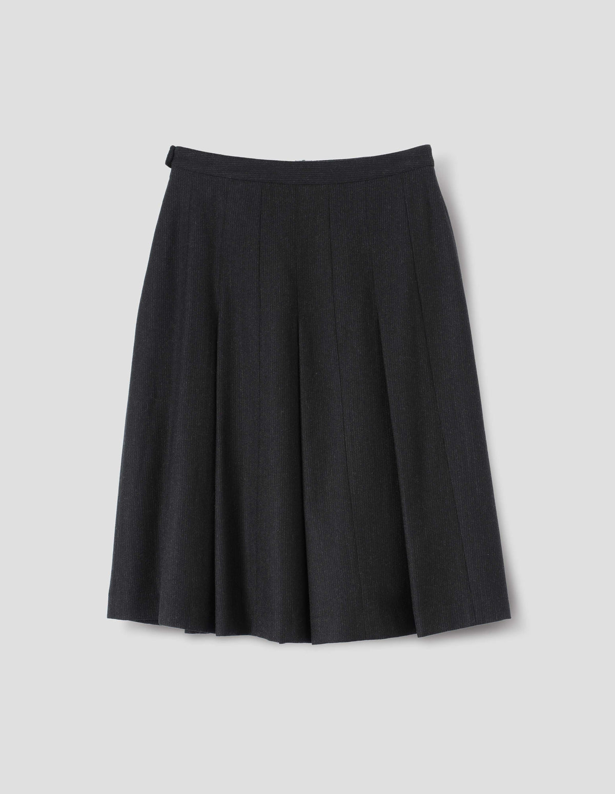 Black wool skirt with dark grey stripes, pleats, narrow horn button-through waistband and side zip fly. Back flat lay view.