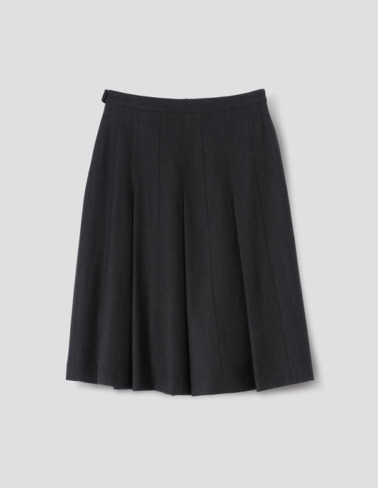 Black wool skirt with dark grey stripes, pleats, narrow horn button-through waistband and side zip fly. Back flat lay view.