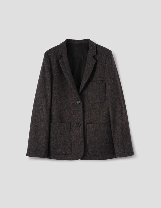 Brown and black herringbone wool blazer with narrow collar and horn button-through revere, three bluff patch pockets, rounded details on hem and pockets. Front flat lay view.