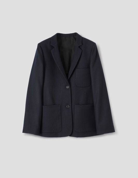 Dark blue wool blazer with narrow collar and horn button-through revere, three bluff patch pockets, rounded details on hem and pockets. Front flat lay view.