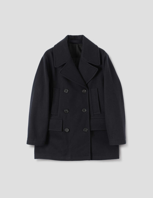 Dark blue wool coat with large collar and revere, double breasted front with horn buttons, high-set single welt pockets and large flap pockets. Front flat lay view.