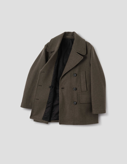 Khaki green cotton lined wool blend coat with large collar and revere, horn buttons, high-set single welt pockets and large flap pockets. Open flat lay view.