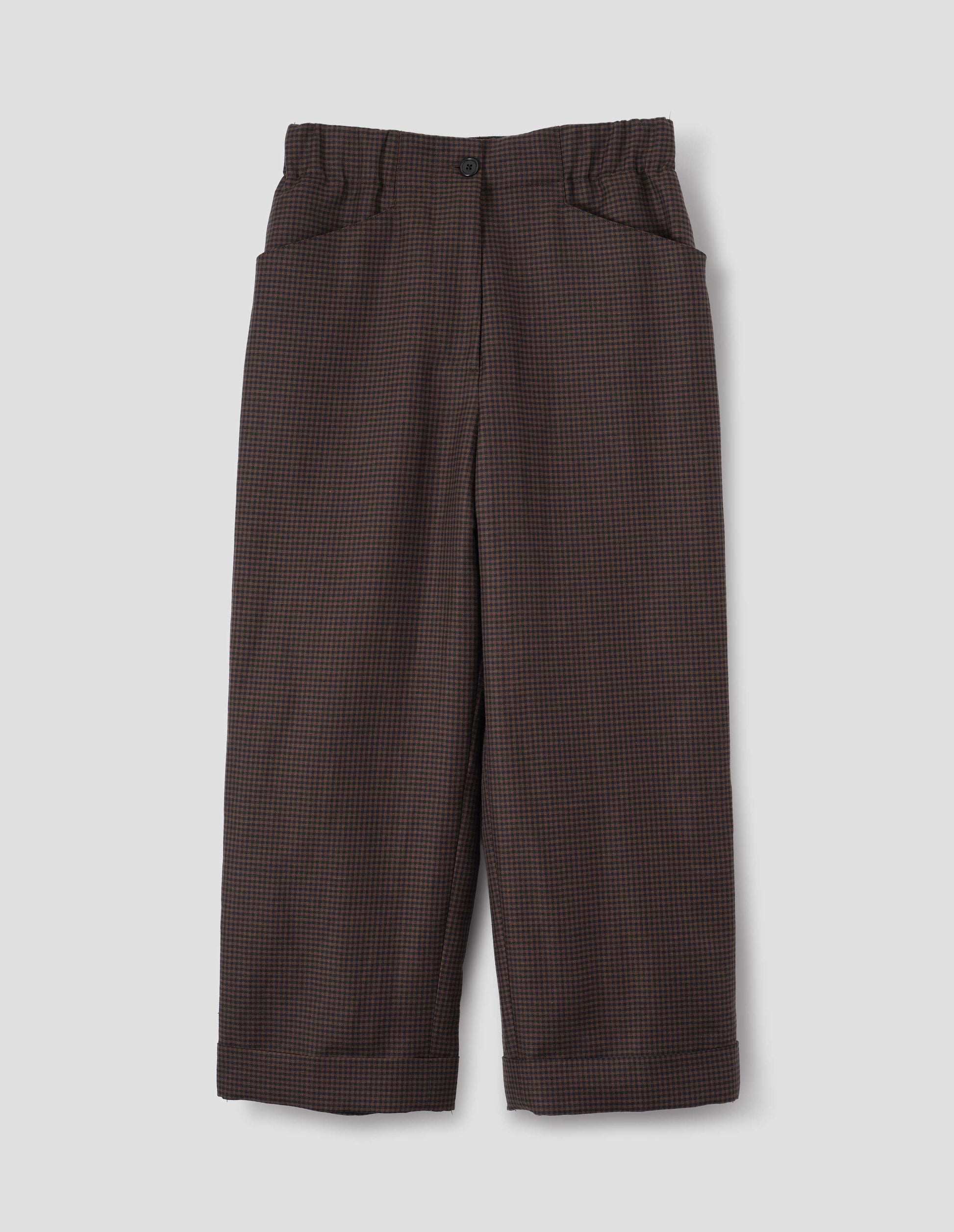Dark blue and dark brown linen wool gingham trousers with zip fly with horn button fastening on elasticated waistband, frog pockets and stitch-down turn-up hem. Front flat lay view.