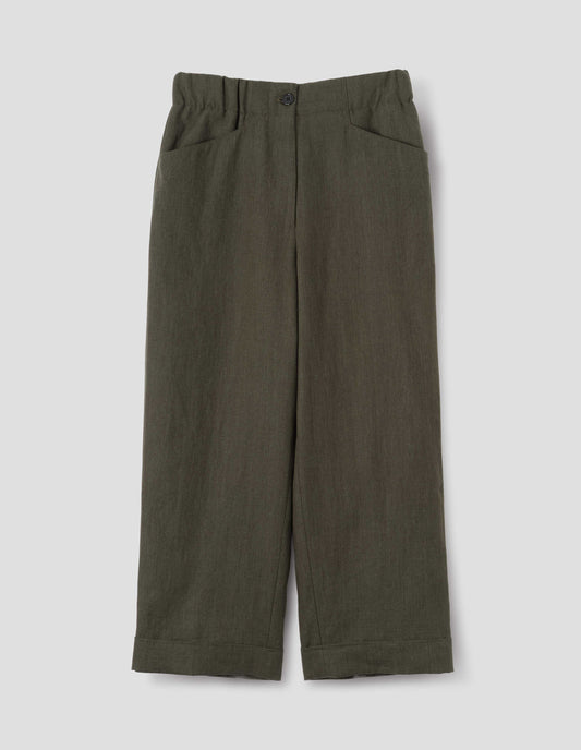 Dark green linen trousers with zip fly with horn button fastening on elasticated waistband, frog pockets and stitch-down turn-up hem. Front flat lay view.