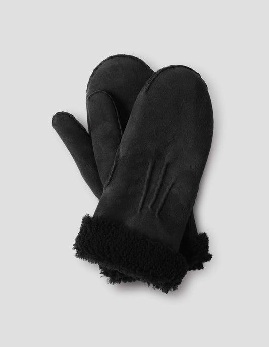 Black shearling mittens with contrasting curly merino cuffs and stitching details on top. Front flat lay view.