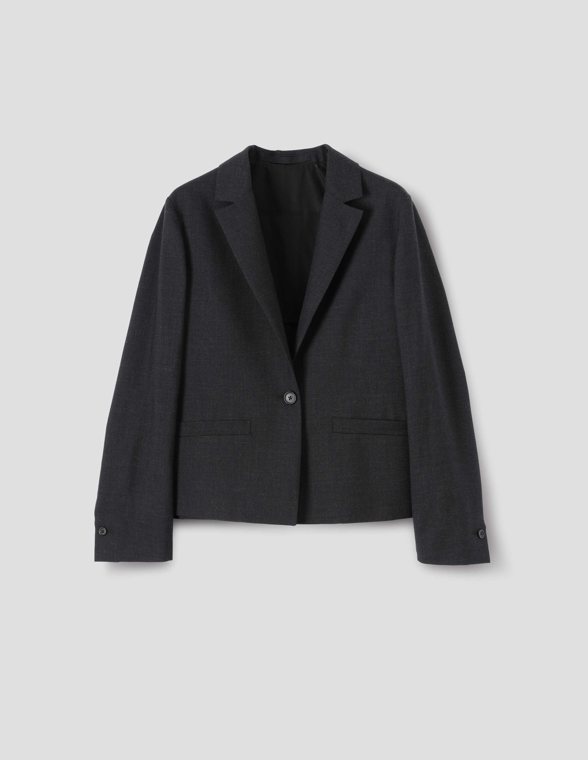 Dark grey wool check blazer with single horn button fastening, welt pockets, horn buttons on cuffs and internal hanger loop. Front flat lay view. 