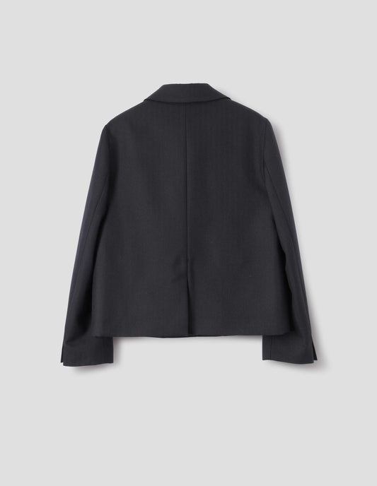Dark blue wool blazer with centre back vent and horn buttons on cuffs. Back flat lay view.