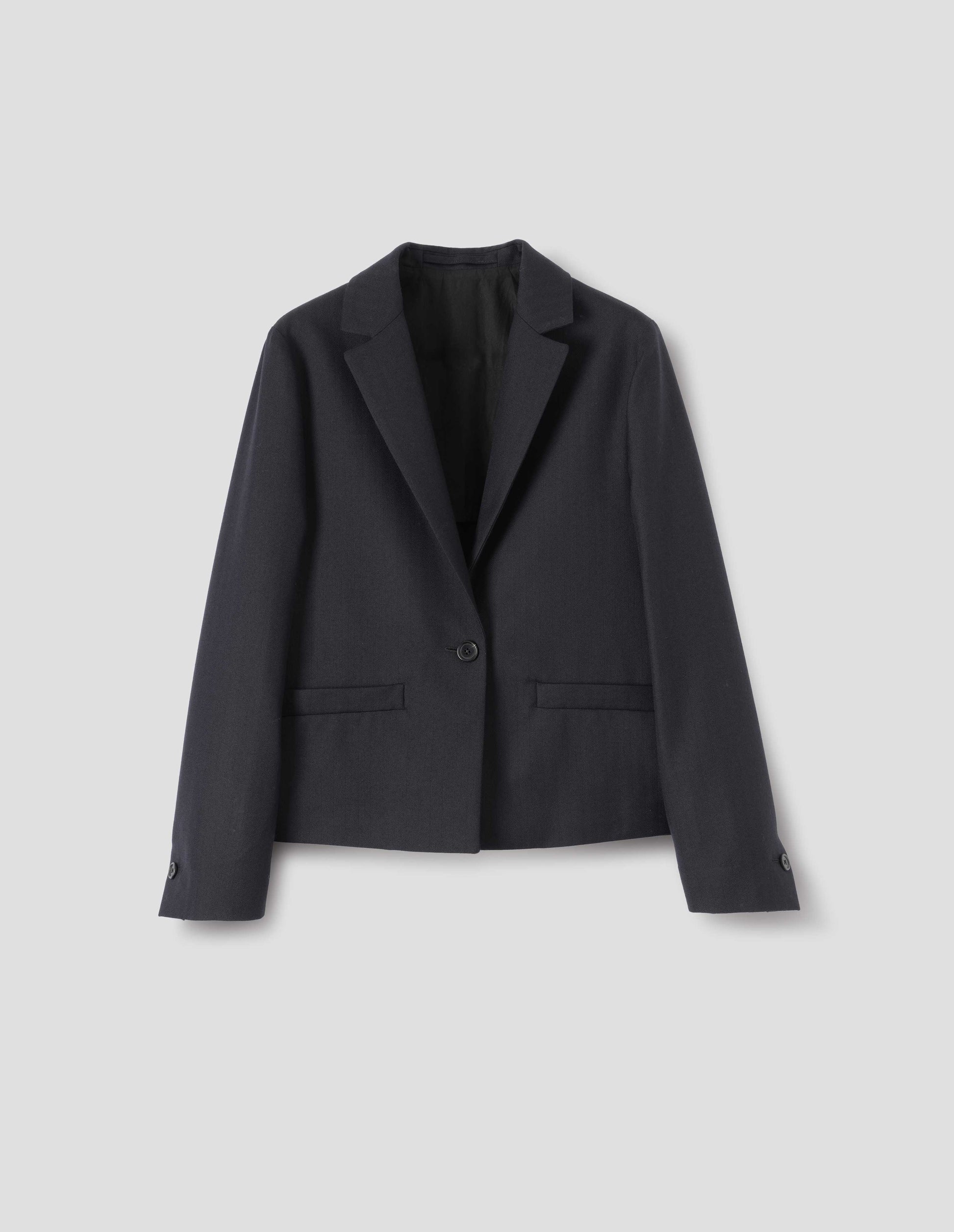 Dark blue wool blazer with single horn button fastening, welt pockets, horn buttons on cuffs and internal hanger loop. Front flat lay view.