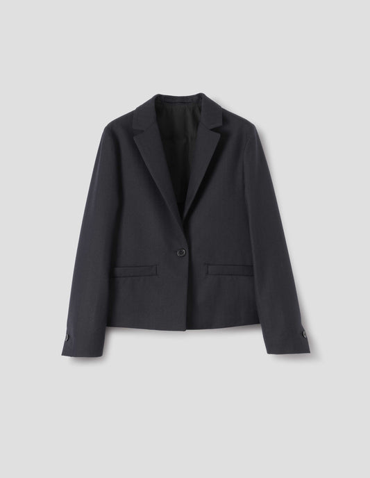 Dark blue wool blazer with single horn button fastening, welt pockets, horn buttons on cuffs and internal hanger loop. Front flat lay view.
