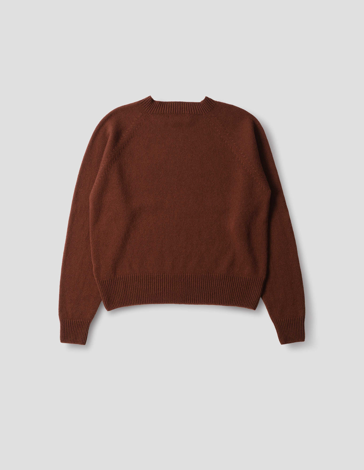 Brown fully fashioned seamless merino cashmere jumper with crew neck, raglan sleeve,  and with ribbed neck, cuffs and hem. Back flat lay view.