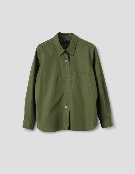 Green cotton shirt with mother of pearl buttons on raised placket, chest patch pocket and curved hem. Front flat lay view.